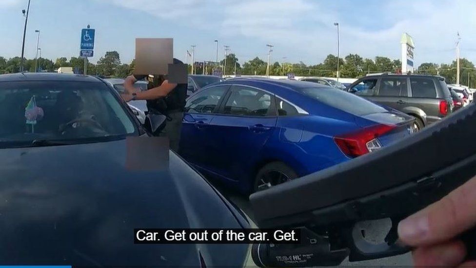 Footage of police with guns drawn