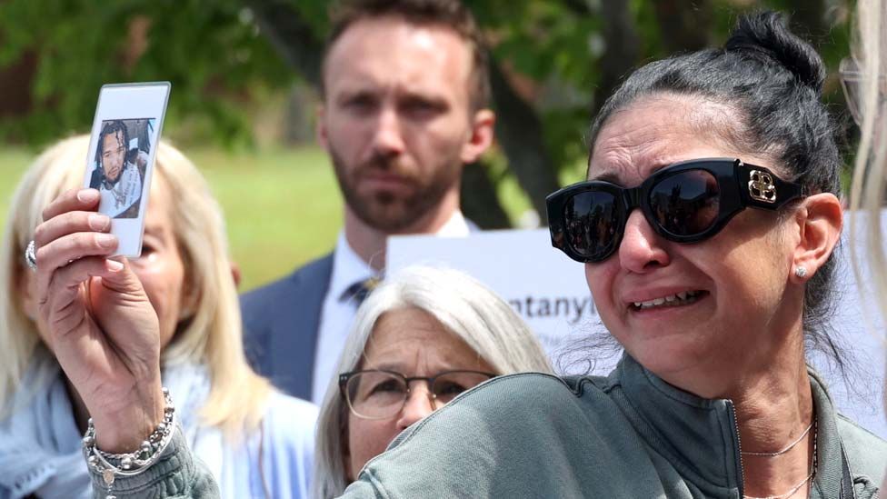 Joanne Pacheco, of Bellport, New York, holds up a photograph of her son Spencer Daniel Burton Jr., who died from a Fentanyl overdose on April 4, 2023, during a press conference outside the Suffolk County Legislature William H. Rogers building in Smithtown, New York, on May 9, 2023