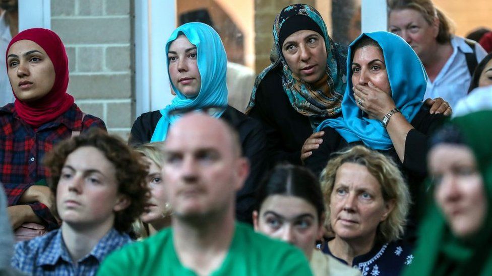 Muslim women stand among other mourners of different faith at a mosque service in Melbourne dedicated to the Christchurch victims.