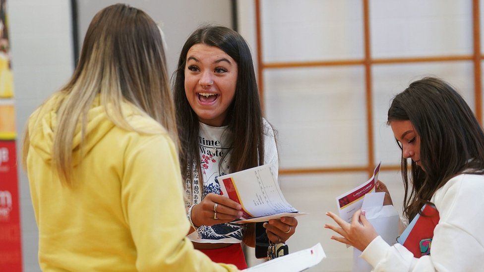 Atlanta Watson (centre) reacts after opening her A-level results at Lagan College, Belfast