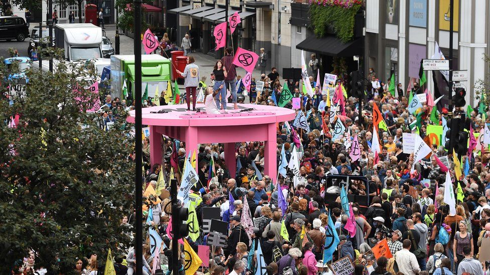 large pink table surrounded by crowds