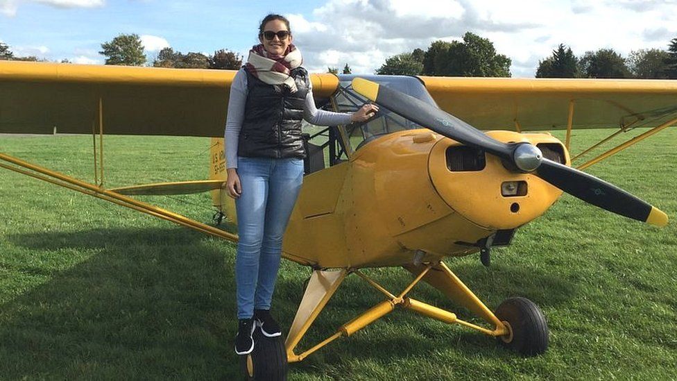 Hannah Kerr from Bristol Groundschool smiling at the camera standing by a small propellor plan