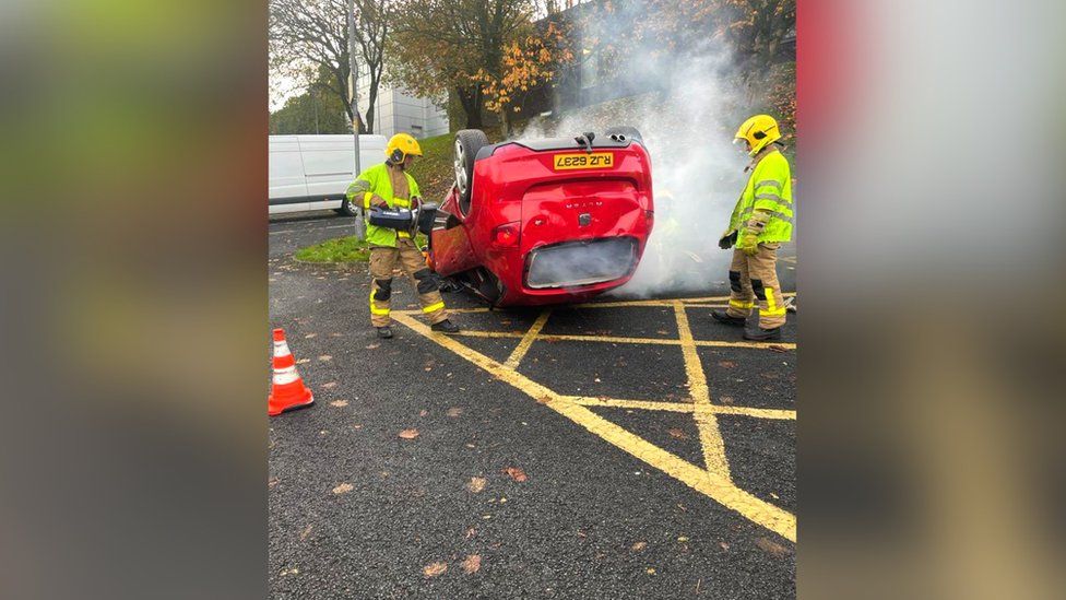 School pupils are given a demonstration of a simulated crash