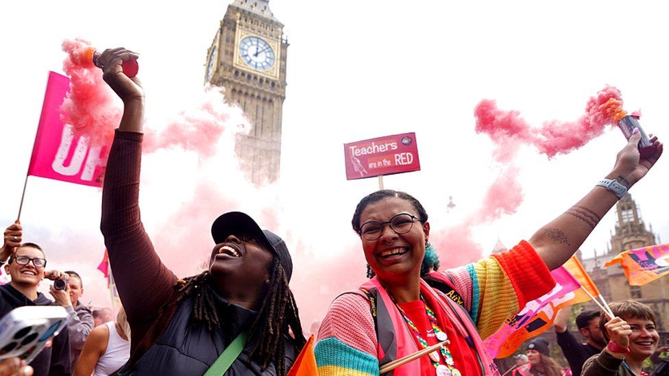 Members of the National Education Union take part in a rally through Westminster as teachers stage walkouts across England.