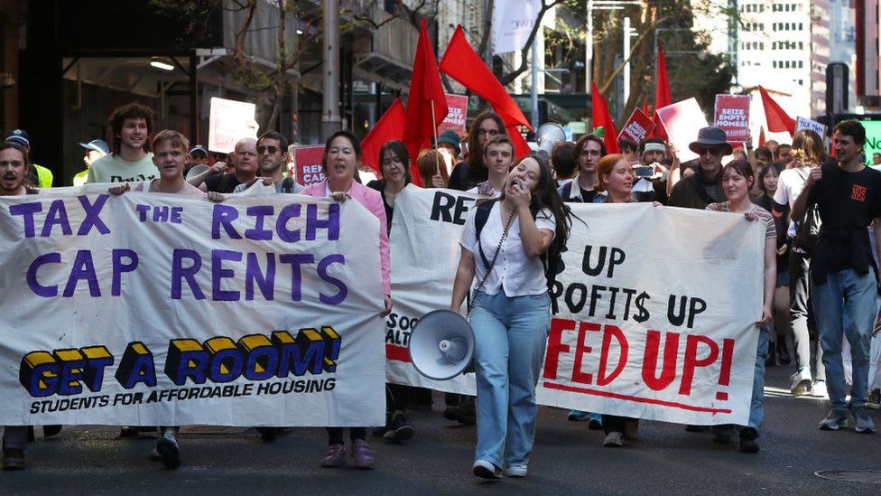 People march through Sydney in a housing rally