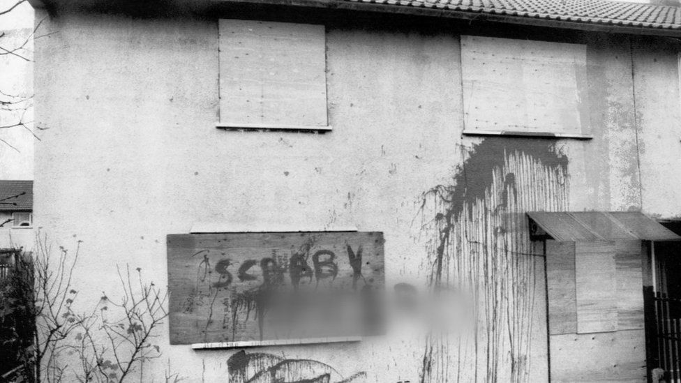 A worked miner's house in Bolton upon Dearne, South Yorkshire, boarded up and daubed with graffiti