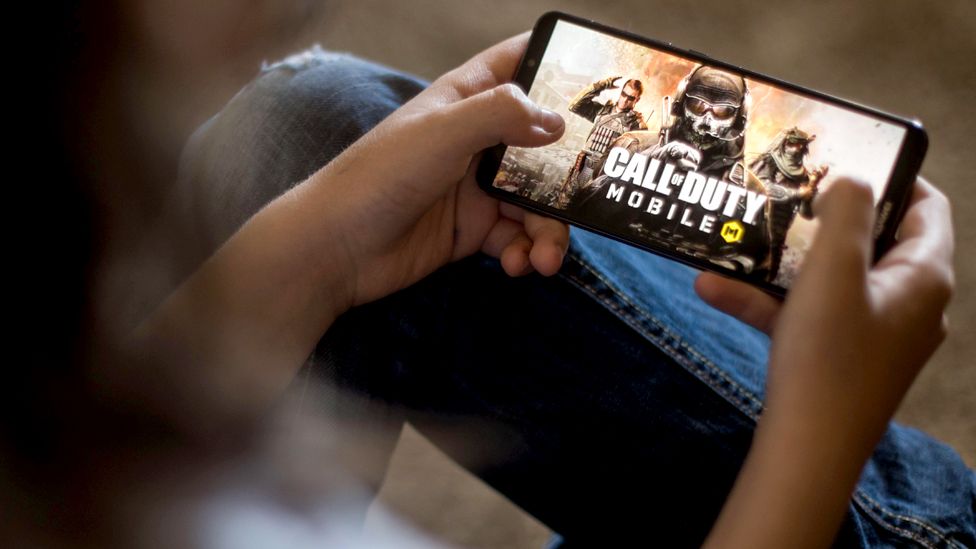 A person plays Call of Duty on their mobile phone
