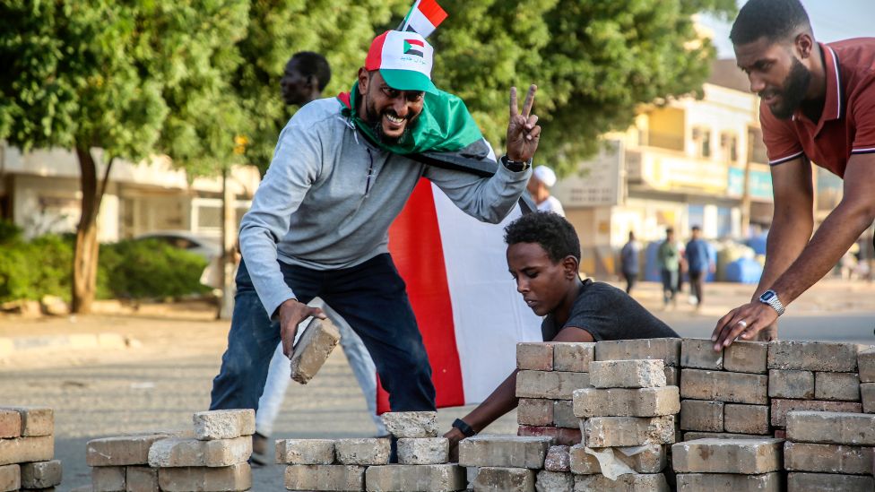Sudanese protesters build a barricade on a street in the capital Khartoum, Sudan - 30 October 2021