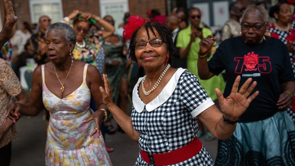 People dance at the celebrations of the 75th anniversary of the arrival HMT Empire Windrush on June 22, 2023 in Tilbury, England