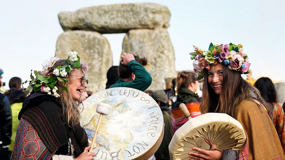 People gather at sunrise to take part in the Summer Solstice at Stonehenge in Wiltshire. Picture date: Wednesday June 21, 2023