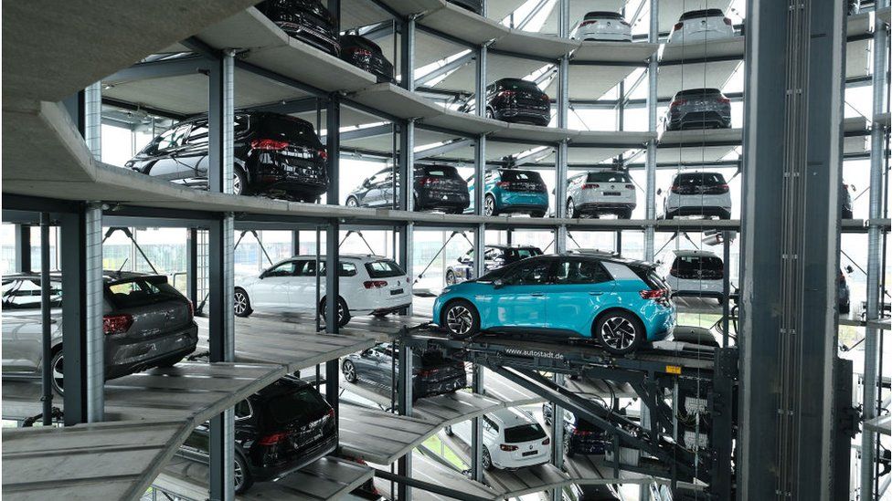 A Volkswagen ID.3 electric car stands on an elevator platform inside one of the twin towers used as storage at the Autostadt promotional facility next to the Volkswagen factory