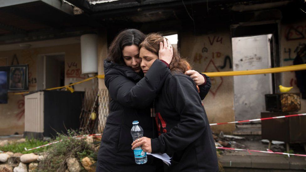 Amit Soussana (r), who was held hostage by Hamas and released hugs a friend near her house where she was kidnapped during the 7 Oct attack on the kibbutz, on 29 January 2024 in Kfar Aza, Israel.