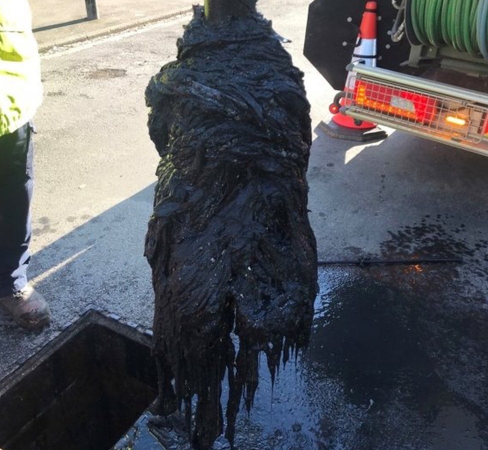 A mass of wet wipes being removed from a sewer