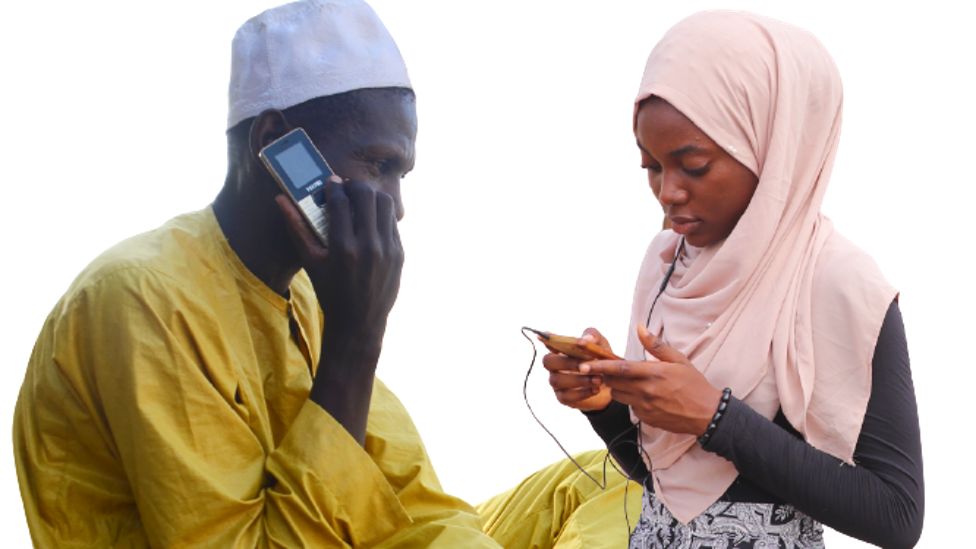 A man and a woman in Nigeria using mobile phones