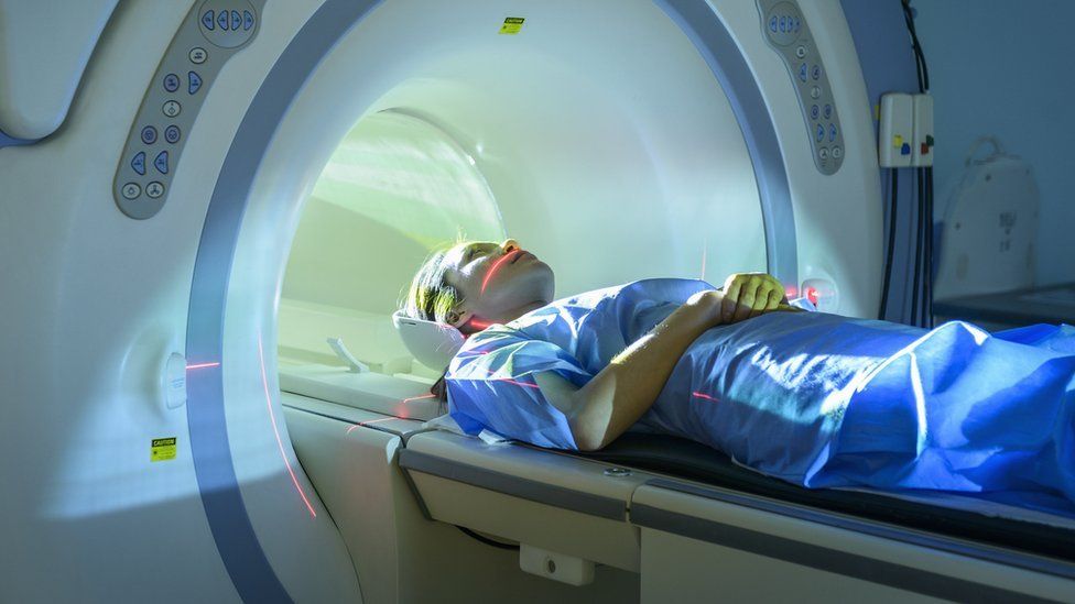 A woman entering an MRI machine