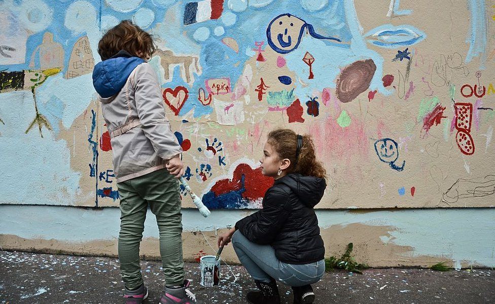 A children painting on the wall near the Le Carillon in memorial of the victims of the terrorist attacks a month ago Paris, France on December 13, 2015