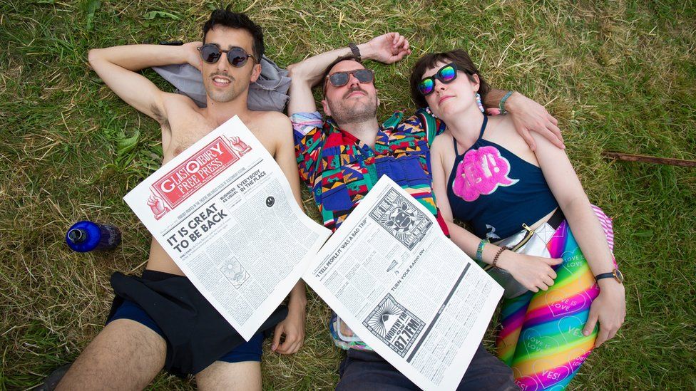 Festival-goers enjoy the sunshine before predicted thunderstorms on the second day of the Glastonbury Festival