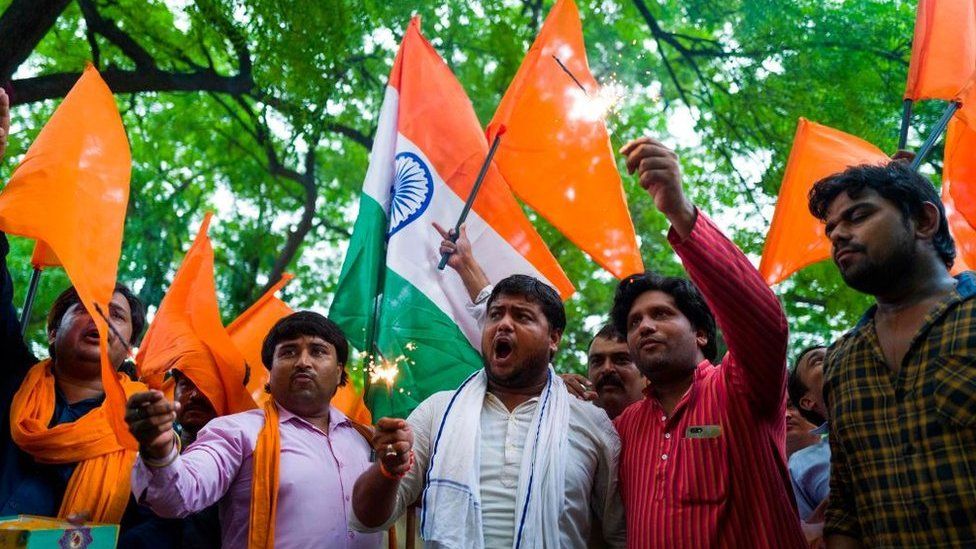 Members of Hindu Sena, a rightwing group, celebrate after the abolition of Article 370 in Delhi