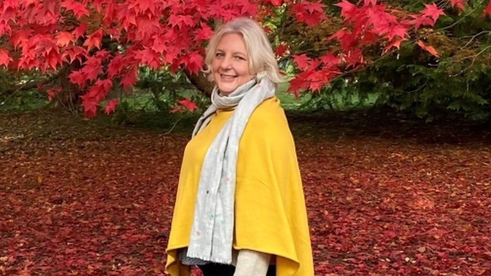 A blonde woman, a mother of two, on a walk in an autumn setting