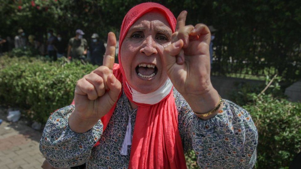 A female supporter of the Islamist party Ennahdha gestures as she chants slogans during a sit-in protest led by the Tunisian Parliament Speaker Rached Ghannouchi, in front of the building of the Tunisian parliament in Bardo, in the capital Tunis, Tunisia, on July 26, 2021