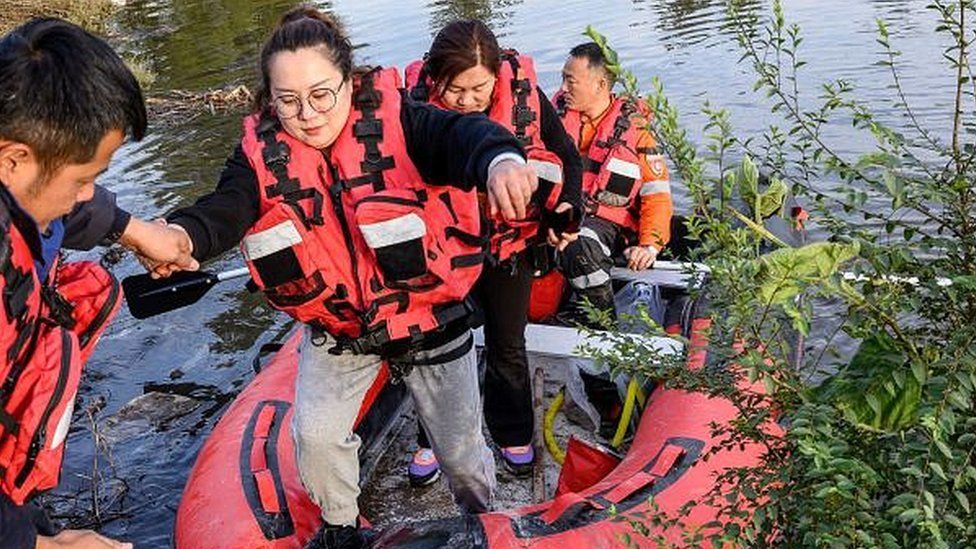 People are rescued after flooding in China's Shanxi province, 11 October 2021
