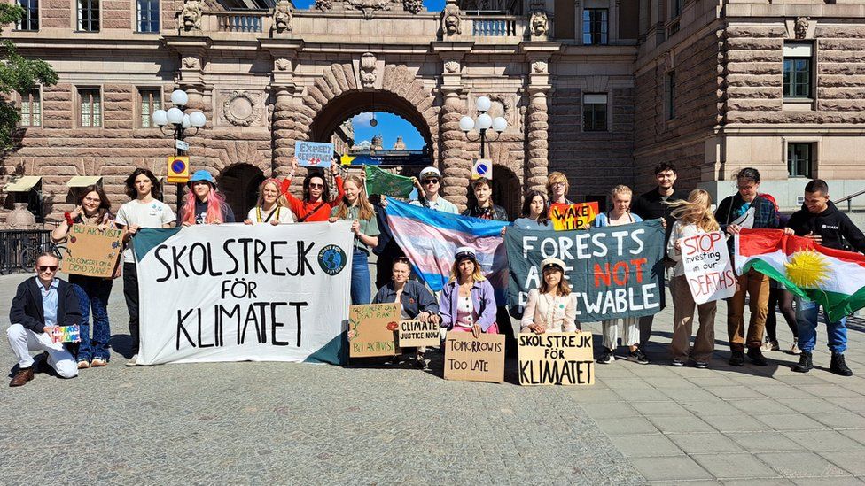 Group of young people with climate change protest banners
