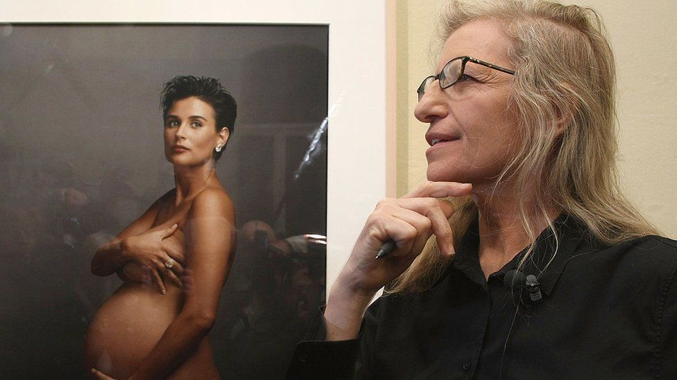 Photographer Annie Leibovitz speaks to the media while standing in front of a portrait of pregnant actress Demi Moore during a walk-through of the exhibition "Annie Leibovitz - A Photographer's Life 1990-2005" at the C/O Gallery on 20 February 2009 in Berlin