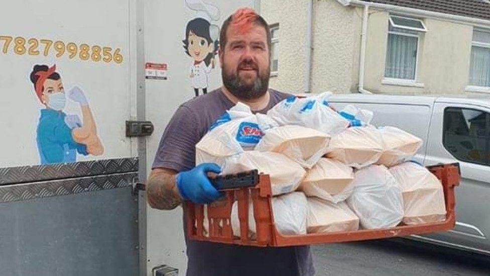 James Thomas AKA 'Beefy' holding food parcels he delivered during the Covid pandemic