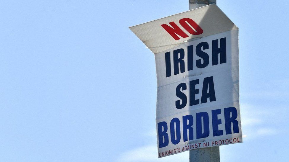 A poster reading "No Irish Sea border" displayed in the port of Larne, Northern Ireland, in June 2022