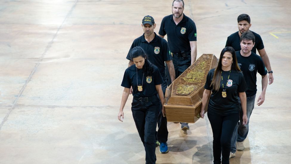 Brazilian police officers transport the casket with human remains found found in the remote Amazon rainforest. Photo: 16 June 2022
