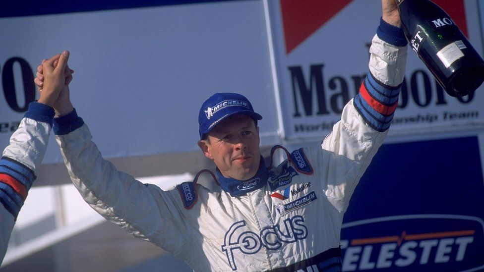 Colin McRae celebrates victory at the Acropolis Rally in Greece in 2000
