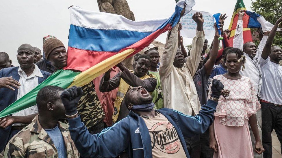 Russians and Malian flags are waved by protesters in Bamako, during a demonstration against French influence in the country on May 27, 2021
