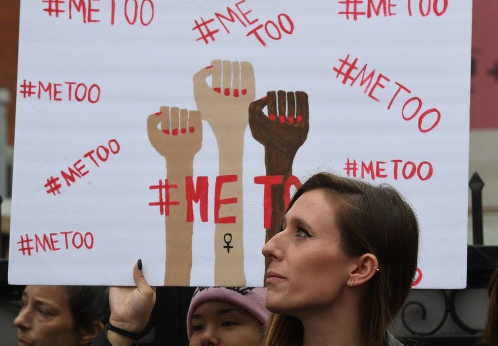 protesters hold metoo signs