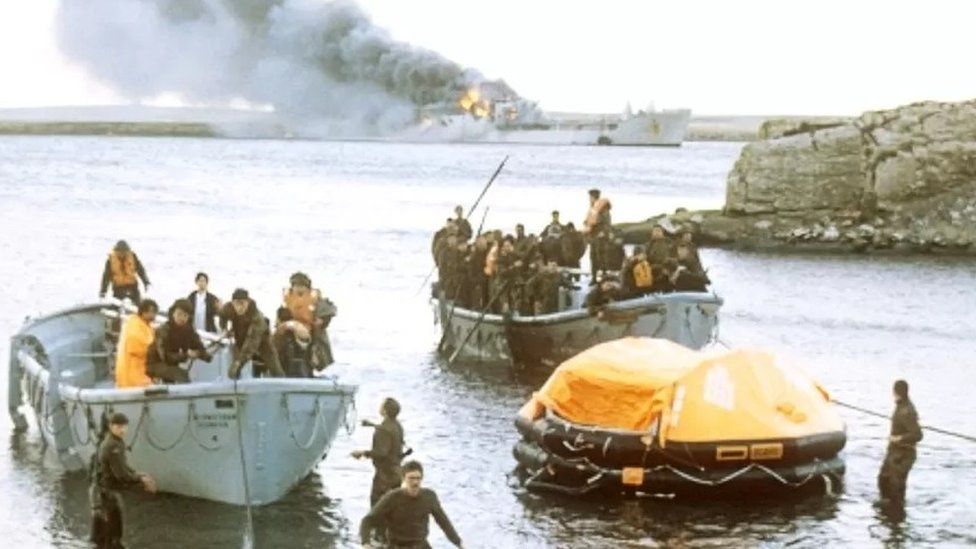 Survivors coming ashore from the bombed Sir Galahad