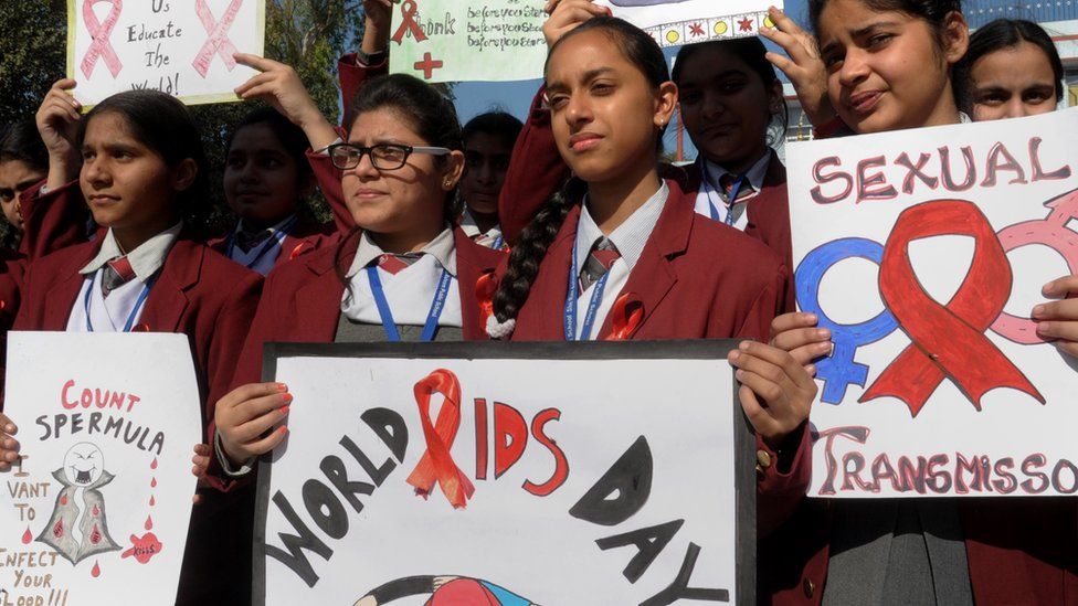 Indian school students taking part in an awareness campaign to mark World AIDS Day at a school on December 1, 2014