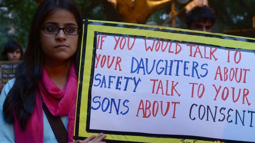 Woman holding a sign against rape in India