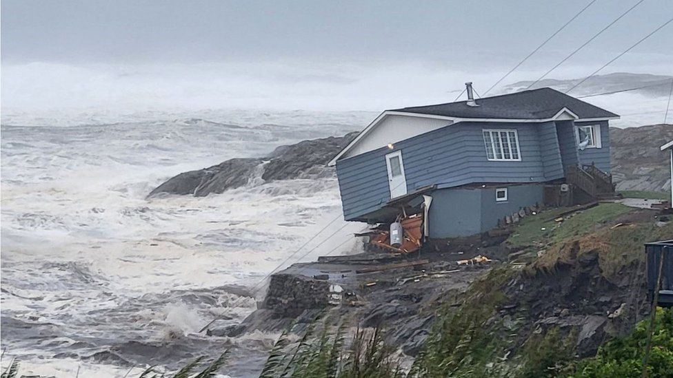 A house looks about to fall into the sea