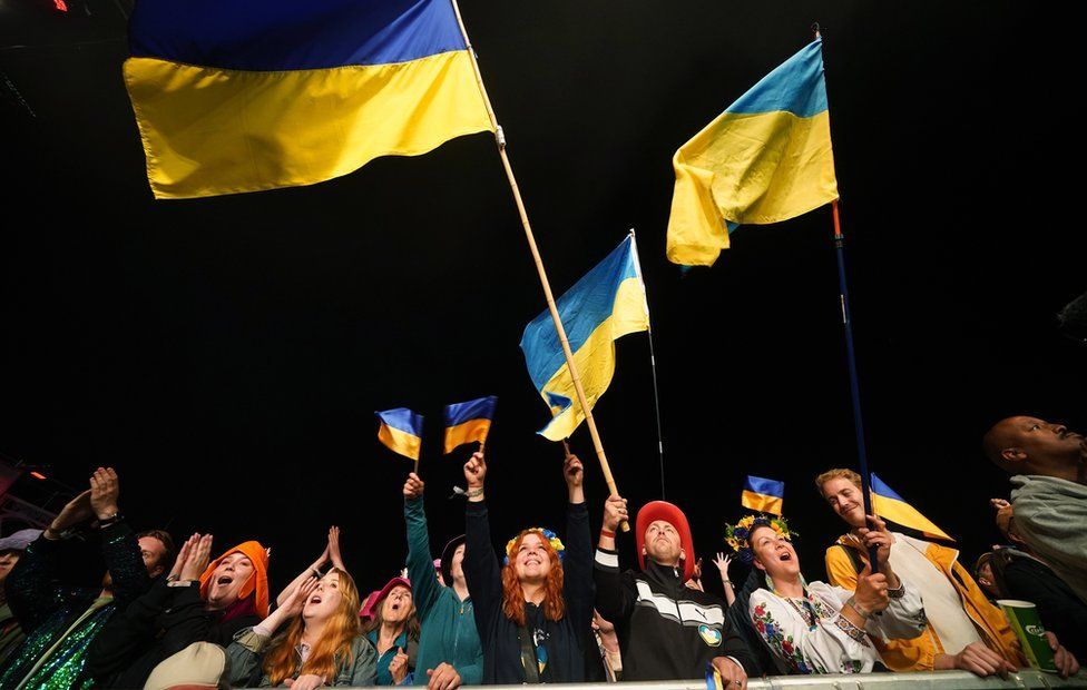 Fans holding Ukrainian flags