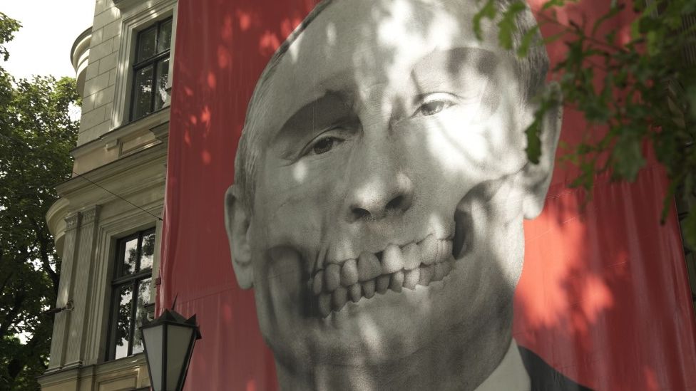 A mural depicting a skull with the features of Russian President Vladimir Putin is displayed opposite the Russian Embassy in Latvia’s capital, Riga.