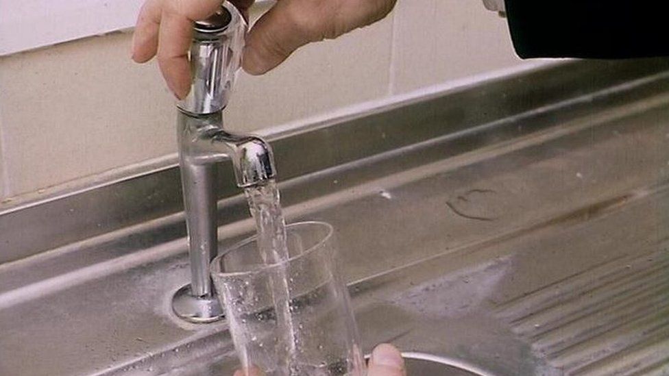 Filling glass of water