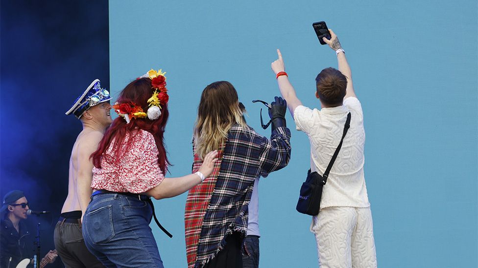 Jared Leto from Thirty Seconds to Mars taking selfies with fans on stage