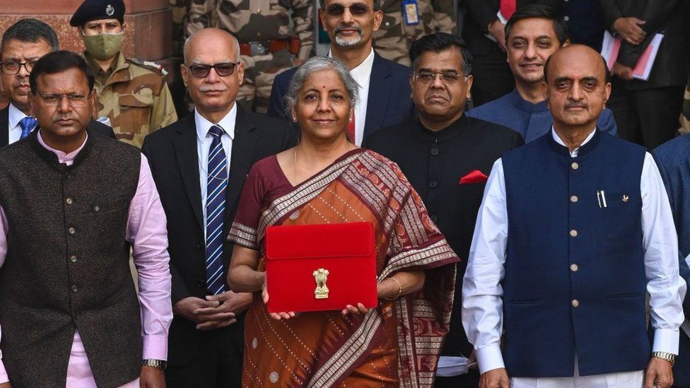 India's Finance Minister Nirmala Sitharaman (C) along with the ministers of state for finance Pankaj Chaudhary (L) and Bhagwat Kishanrao Karad (R) leaves the ministry of finance to present the annual budget at the parliament in New Delhi on February 1, 2022.