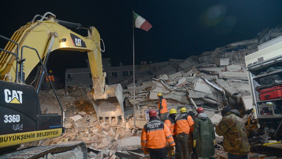 Residents and rescue personnel search for victims and survivors through the rubble of the collapsed hotel in Adiyaman, in the night of 8 February 2023