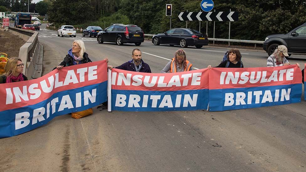 Insulate Britain protesters blocking a busy road