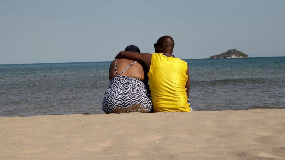 A couple is seen resting on the shores of Lake Malawi at Senga bay Salima (archive shot)