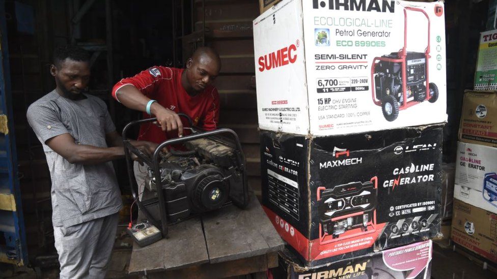 Technicians repair a generator in a shop at Yaba district of Lagos