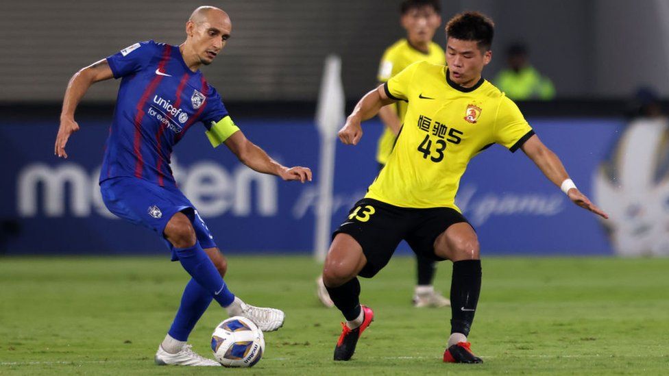 Natxo Insa of Johor Darul Ta'zim controls the ball under pressure of Chen Zhengfeng of Guangzhou FC during the AFC Champions League Group I match on 15 April, 2022.