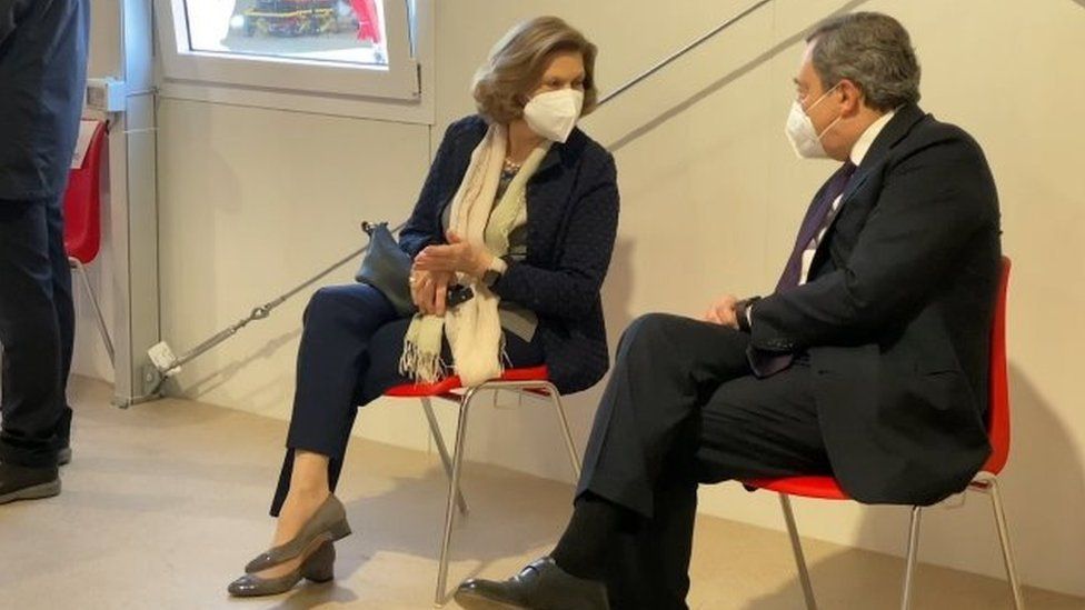 Mario Draghi and his wife Maria Serenella Cappello speak in a waiting room after receiving their first doses of the AstraZeneca jab