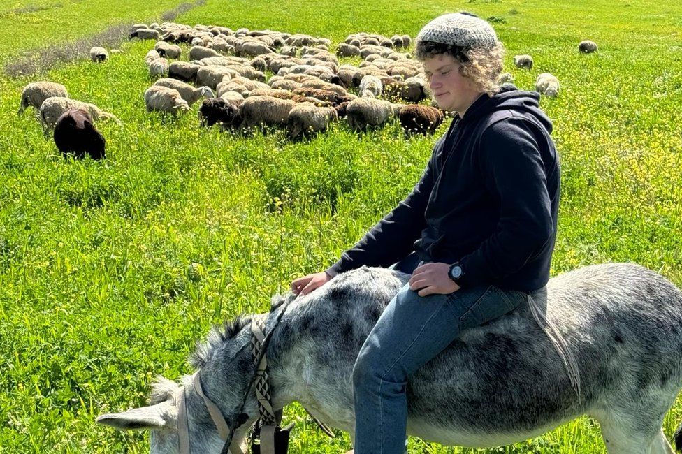 March 2024 photo showing Binyamin Ahimeir, 14, tending sheep near the settler outpost of Malachei Shalom