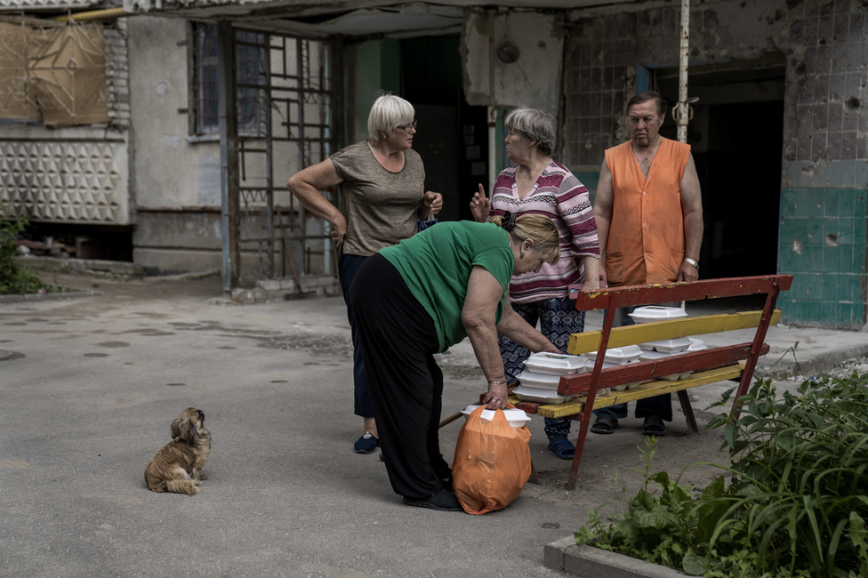 Saltivka residents collect free meals delivered once a day by a food charity. For many, it is there one meal a day now